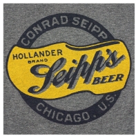 Zoomed in image of the frontside of a grey crewcut t-shirt showing the Seipp's Beer logo. A black ribbon in a circle says "Conrad Seipp, Chicago, U.S." and inside the circle is a yellow clog with the cursive text "Seipp's Beer, Hollander Brand"