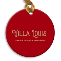 The back of a round holiday ornament. Solid red background with the words Villa Louis across the middle.