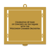 Back of 2023 State Capitol Ornament with inscription that reads "Celebrating 40 years of Concerts on the Square with the Wisconsin Chamber Orchestra." Black text on gold-tone metal. 