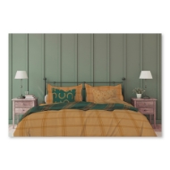 Bed with comforter set with tan and green "Iron Works" design. Green pillo with horseshoe motif.