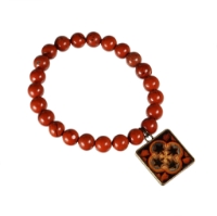 Natural red stone bead bracelet with square charm attached.