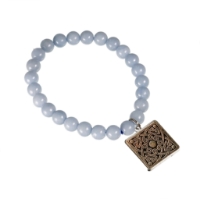 Natural stone bead bracelet with light bluish gray spherical stones and square charm attached.