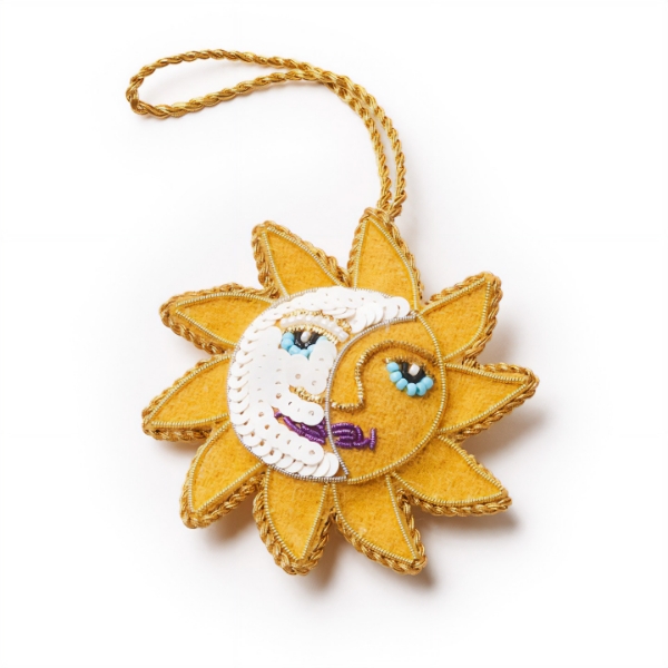 Yellow sun and moon face ornament in the shape of the sun.