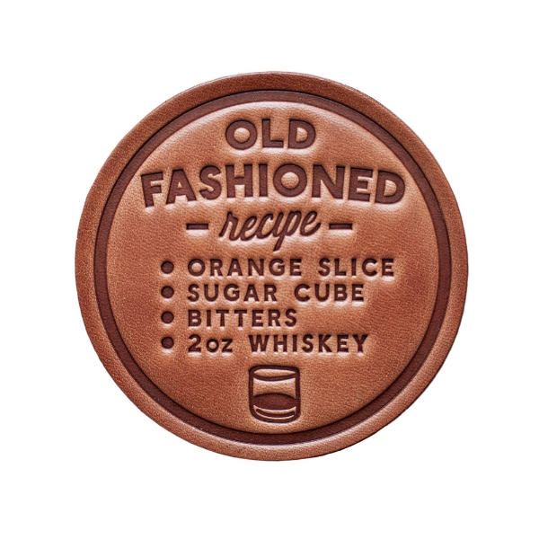 Round, brown leather coaster with whiskey old fashioned recipe embossed. 