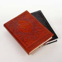 Two journals with leather covers embossed with the shape of Wisconsin surrounded by birds and leaves. One brown, one black.